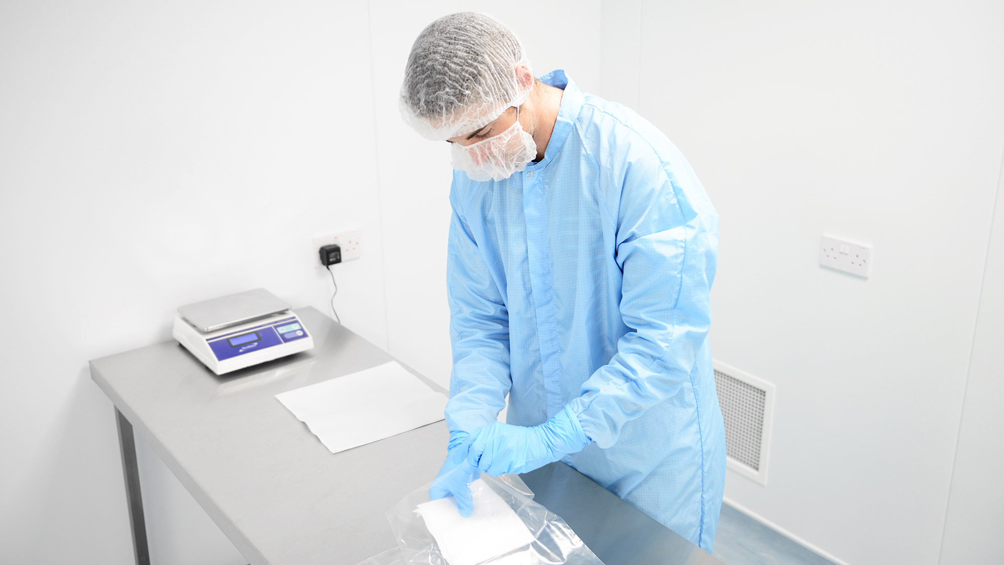 Photo of cleanroom operative working in a cleanroom - Integrity Cleanroom
