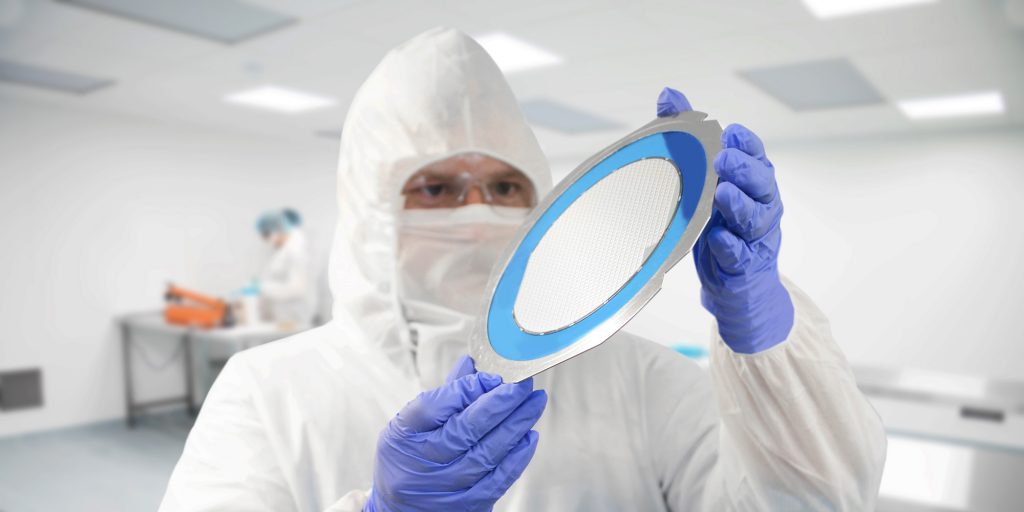 Photo of a water being held by a person in a cleanroom - Integrity Cleanroom